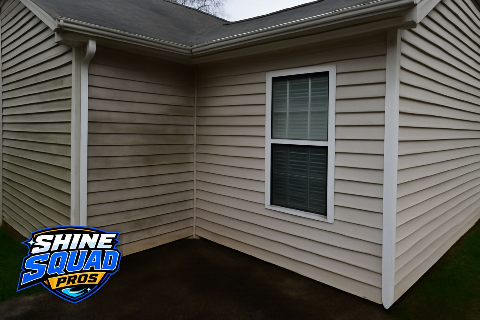 Technician pressure washing a concrete driveway at an Alpharetta, GA residential property